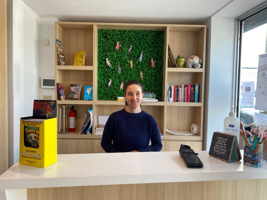 Shivlav Mayo, owner of Westboro Books, stands at the checkout at the front of the store