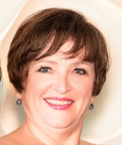 An image of a woman with brown hair. 